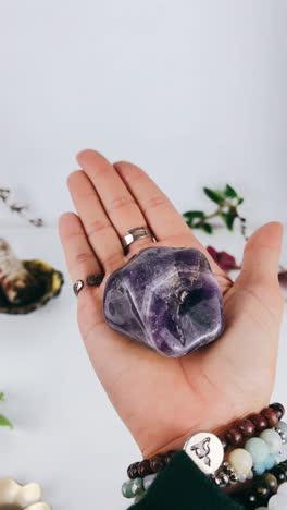 amethyst crystal held in hands