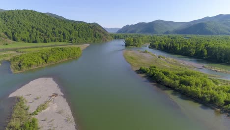 aerial view of a river flowing through a lush green valley