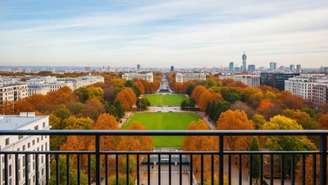 A Stunning Urban Landscape Captured in Autumn: A Panoramic View Showcasing Vibrant Fall Colors and City Skyline Under Clear Skies