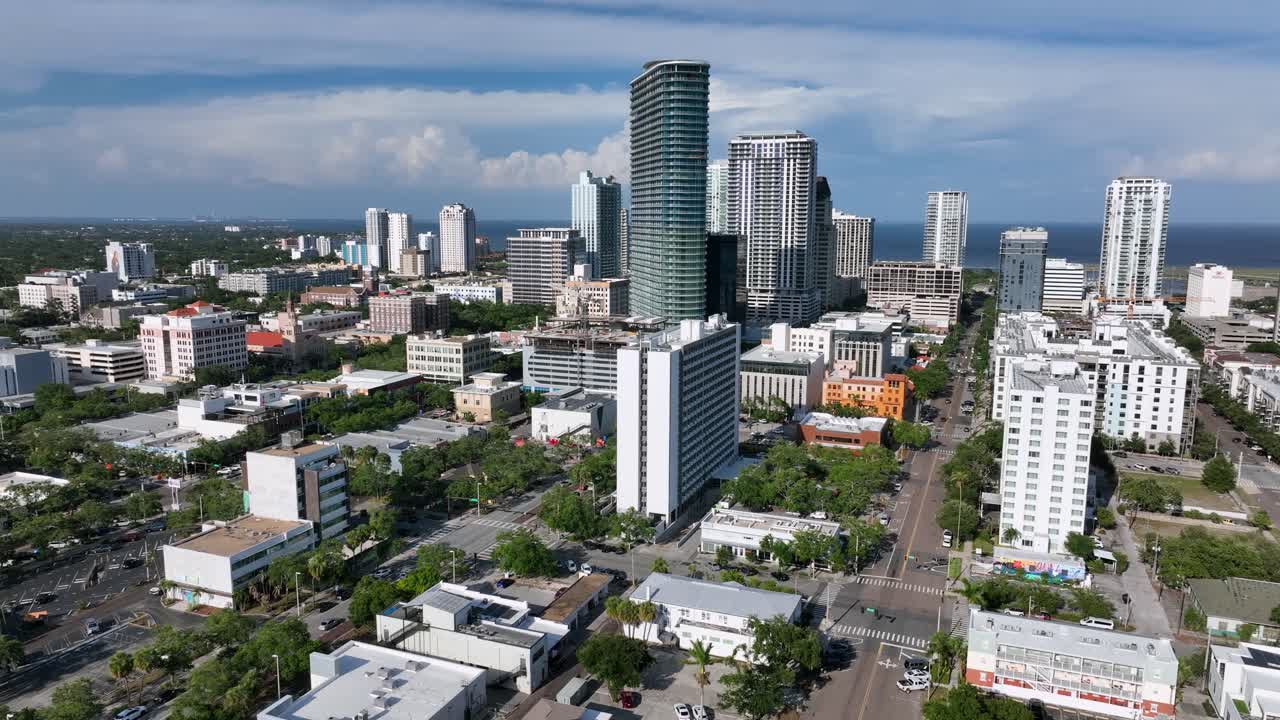 The Residences at 400 Central Tower in Downtown of Saint Petersburg. Aerial wide shot. Golden sunset in american town of Florida,USA. Cars and Vehicles on street and junction.