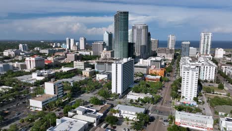the residences at 400 central tower in downtown of saint petersburg. aerial wide shot. golden sunset in american town of florida,usa. cars and vehicles on street and junction.
