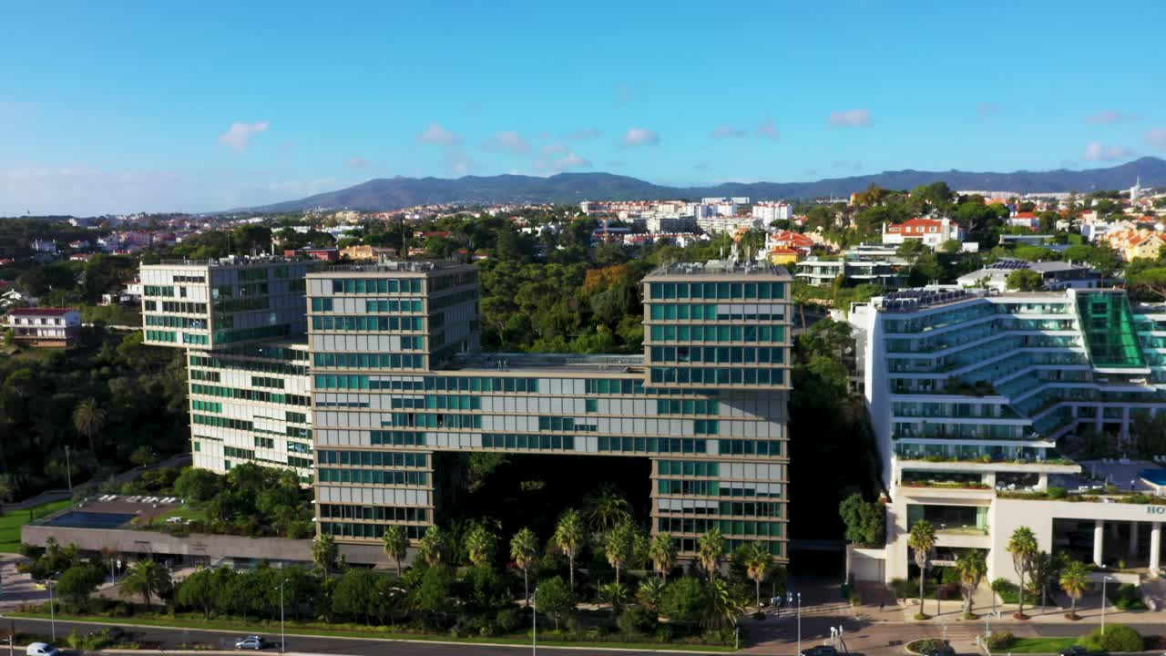 Estoril Sol Residence - Modern Apartment Building Next To Hotel In Cascais, Portugal. aerial sideways shot