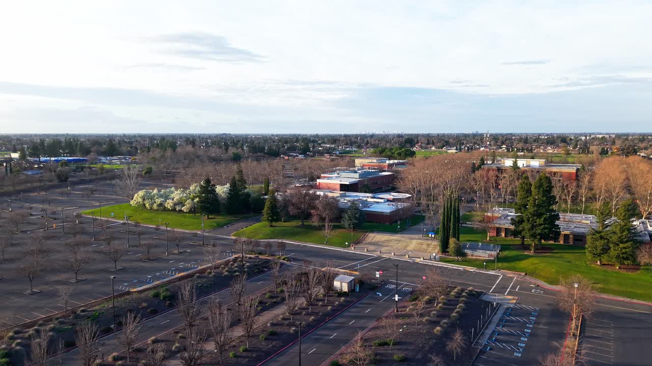 Drone footage captures Cosumnes River College bathed in late afternoon light, where sunlit geometry, long shadows, and warm color create a refined and tranquil campus atmosphere