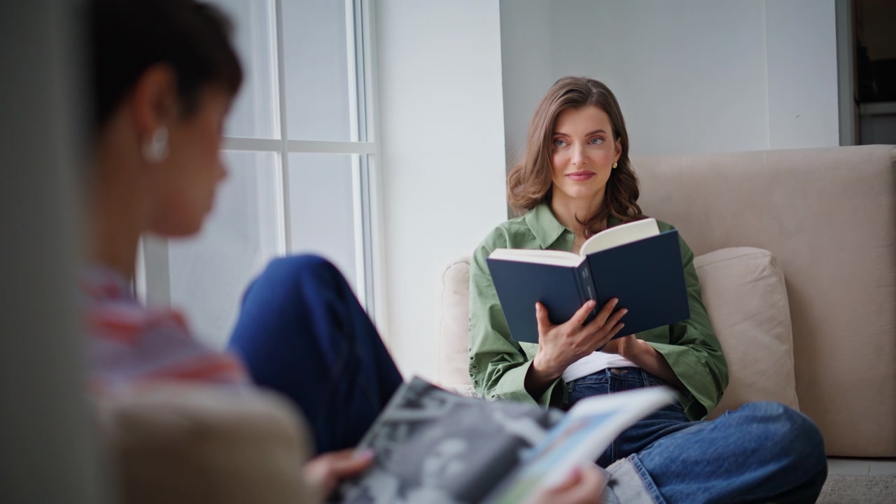 Couple ladies reading home enjoying calm leisure closeup. Women sharing hobby