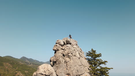 reaching the summit of a rock formation