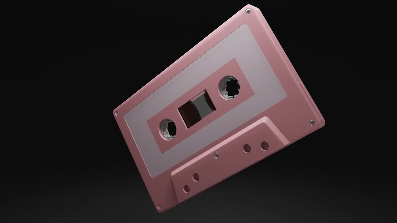 Pale pink cassette tape isolated on black background.