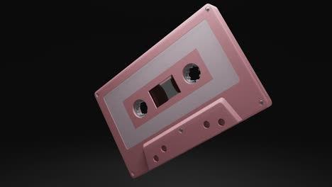 pale pink cassette tape isolated on black background.