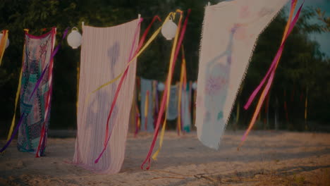 dancing women's shadow on sarongs hanging by ribbons