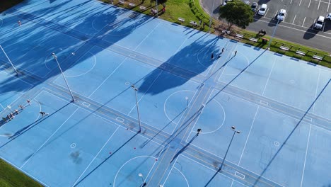 aerial view of outdoor multi-sport court with people playing