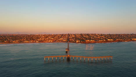 ocean beach pier during twilight, drone perspective