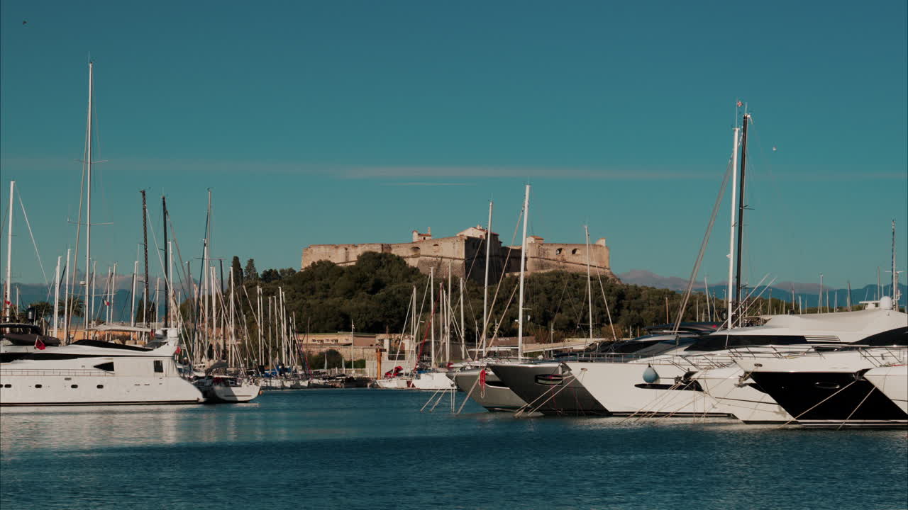 Boats docked in the Port Vauban with he Fort Carre on the background in Antibes, France