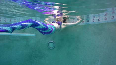 Underwater-view-of-a-Beautiful-Caucasian-woman-mermaid-relaxing-in-the-pool