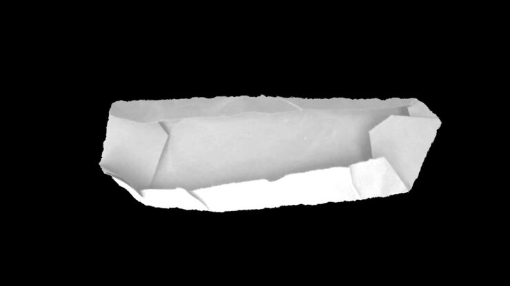 A piece of crumpled white paper on a black background