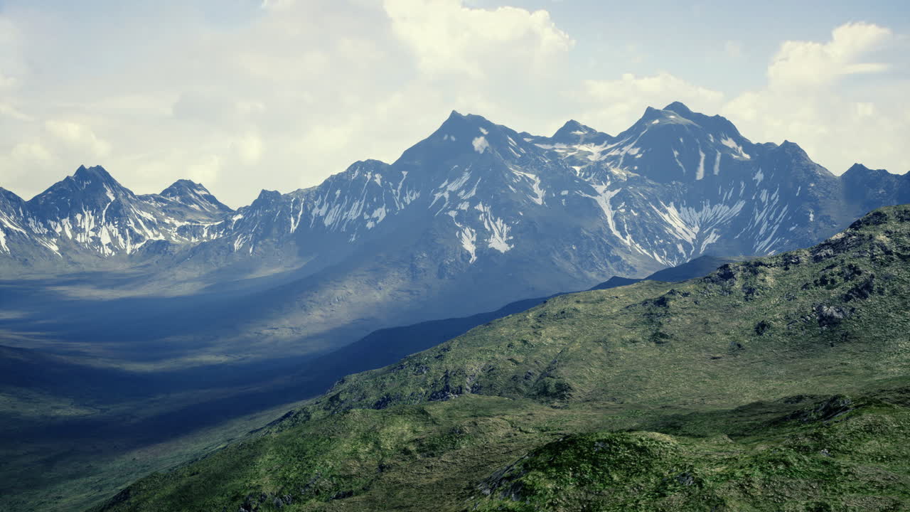 Majestic mountain range with lush greenery under a cloudy sky