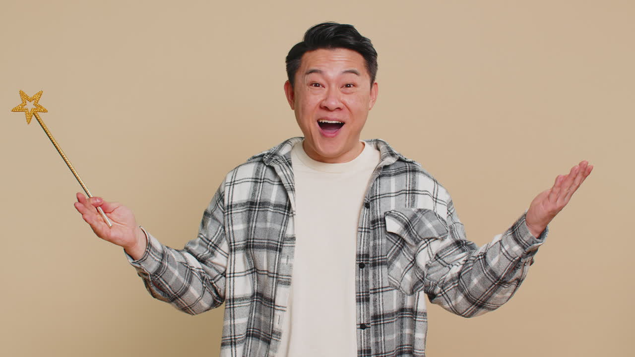 Magician witch asian man gesturing with magic wand making wish come true casting magician spell