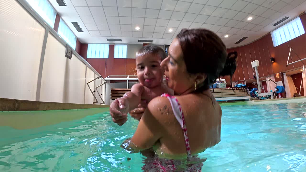 Mother and child swimming in a pool