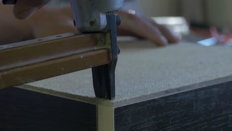 using a nail gun to assemble furniture