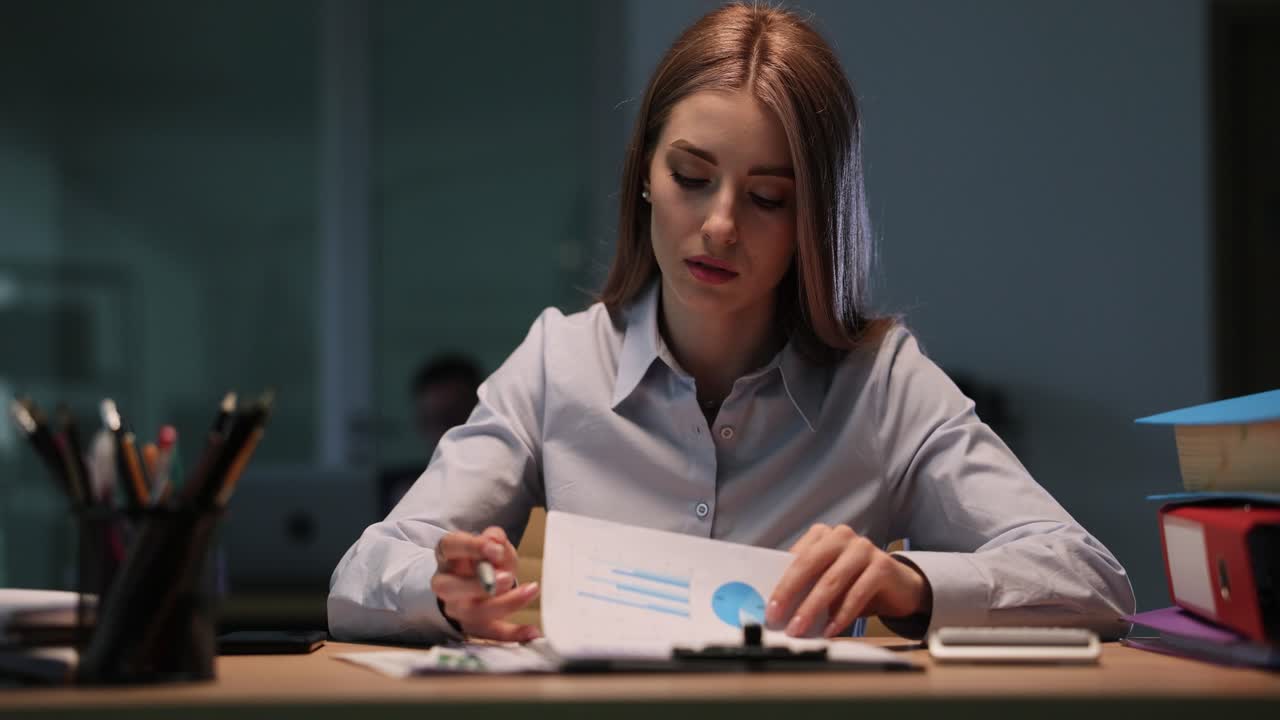 Woman working with documents in office