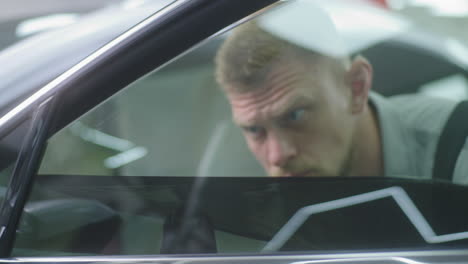 mechanic inspecting car window