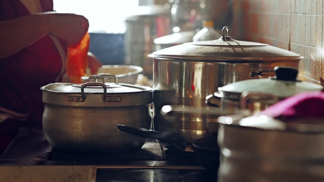Homemade meal preparation in pots showing traditional cooking for many people