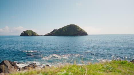 Slow-motion-view-of-Villa-Franca-do-campo-Island-from-the-rocky-shore-of-Sao-Miguel-in-the-Azores---Portugal