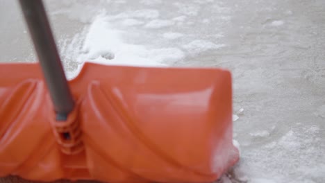 snow shoveler removing snow from sidewalk