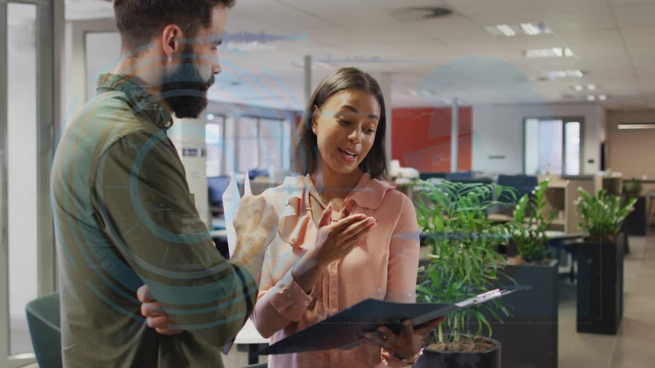 Pair reading folder in biz, woman pointing sparking blue waves rising then fading, clarifying data