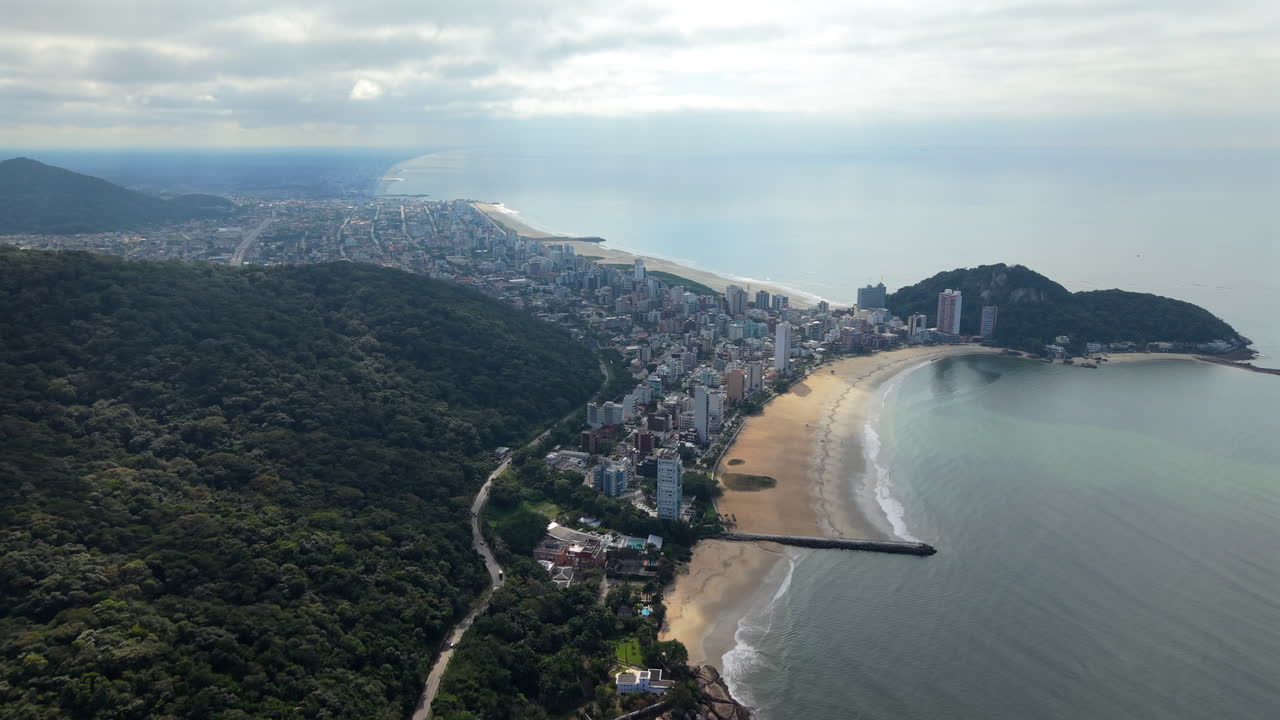 Aerial View of a Coastal City with Beach and Mountains
