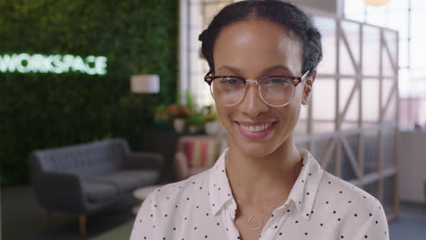 portrait-confident-business-woman-smiling-happy-entrepreneur-enjoying-successful-startup-company-proud-female-manager-wearing-glasses-in-trendy-office-workspace