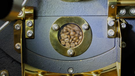 roasted coffee beans in modern machine with roaster
