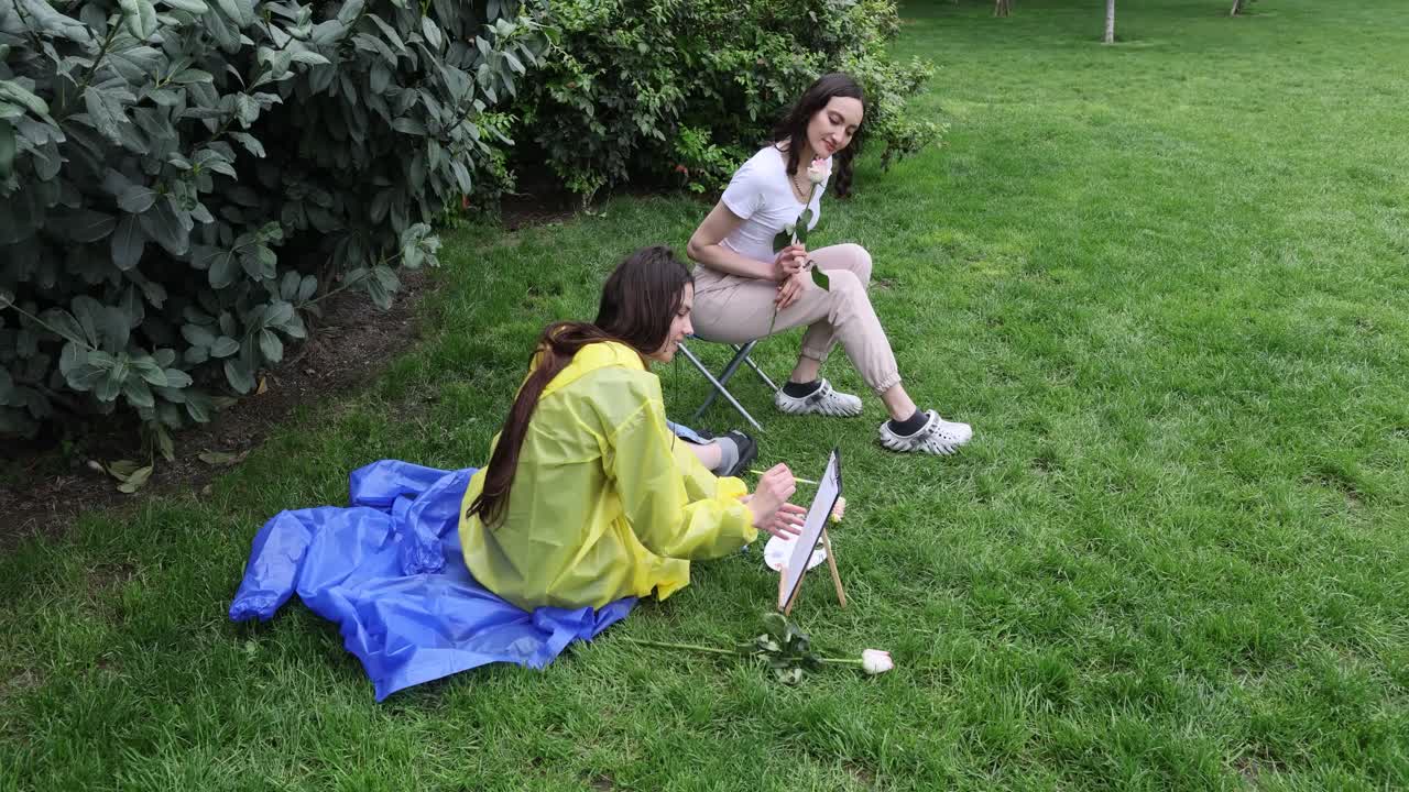 Two women painting in a park