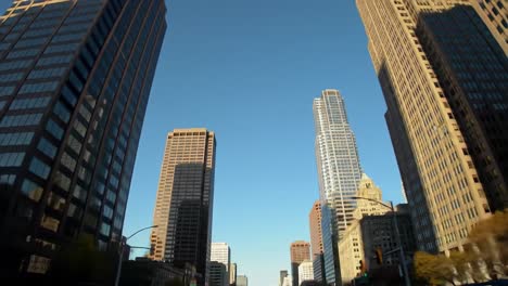 experience the beauty of a lively city as sunlight reflects off the towering skyscrapers, showcasing modern architecture against a bright blue sky. the lively atmosphere invites exploration.