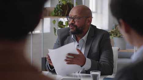 african american businessman sharing creative ideas for startup project team leader meeting with colleagues discussing corporate strategy in office boardroom