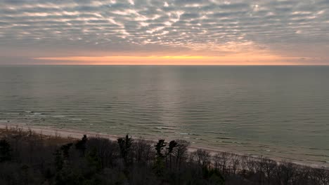 sun setting across the horizon of lake michigan