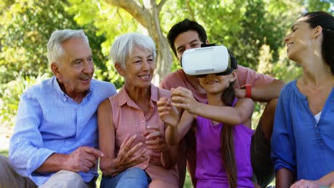 girl using vr headset while sitting with her family 4k