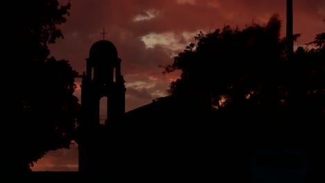 An-old-California-style-mission-bell-tower-against-a-sunset-sky