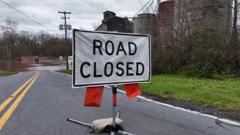 road closed sign in front of flooded street in usa