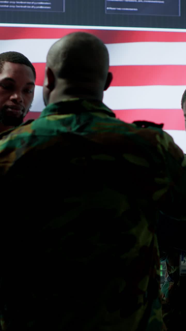 Vertical Video American army officers in high tech command center monitor cybersecurity threats