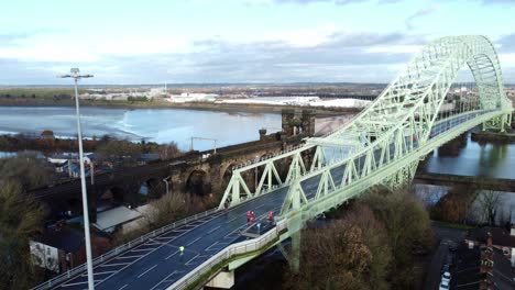 charity santa dash fun run over runcorn silver jubilee bridge aerial view orbit left