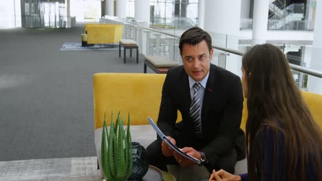 Business-people-discussing-over-document-on-sofa-4k