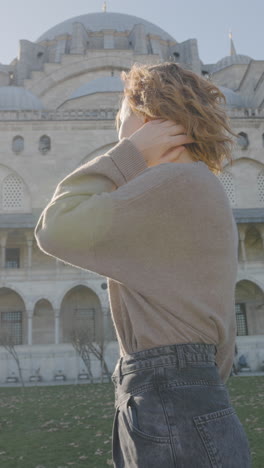 woman in front of a turkish mosque