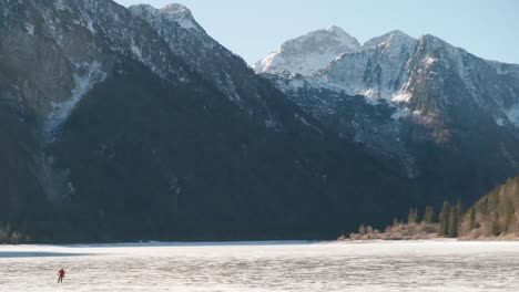 lago del predil, tarvisio - italy a frozen alpine lake in a snow-covered winter fairytale mountain landscape