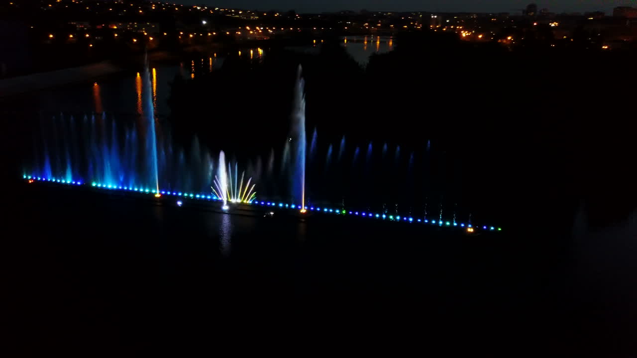 Beautiful Dancing Fountain. Aerial shot of the colorful illuminated musical fountain at dusk