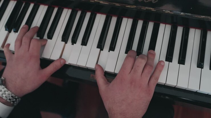 Close view of man playing piano with both hands in Portugal
