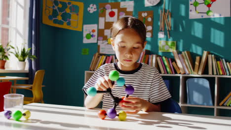 student building a molecular structure model for science education