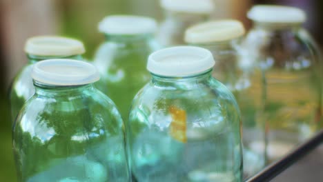 close-up shot of empty juice glass jars mostly used for fruit juices in summer