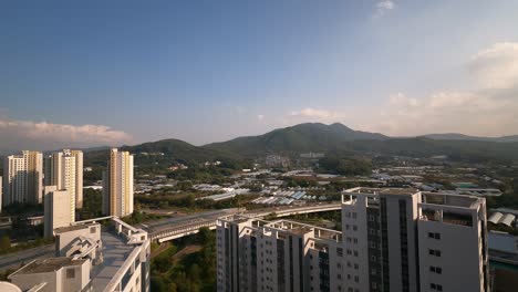 Seoul time-lapse - clouds movement over Guryongsan and Cheonggyesan mountains and high rooftops Seocho Hills and Nature Hills Apartment buildings complexes daytime