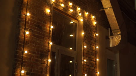 string lights decorated brick wall at night