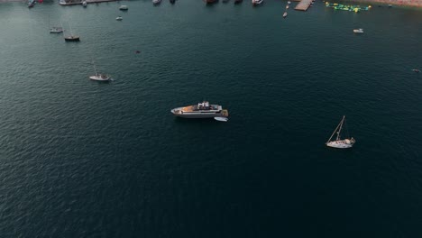 boats float peacefully in the sunset off the coast of saranda, albania, creating a serene scene