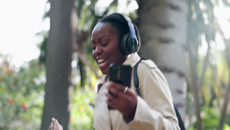 Happy-black-woman,-phone-and-dancing-in-park-to